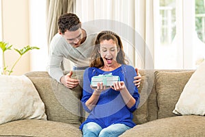 Woman receiving a surprise gift