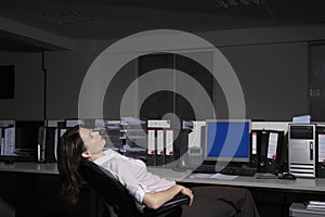 Woman reclining on chair in office