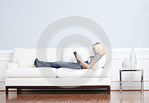 Woman Reclining on Couch With Book