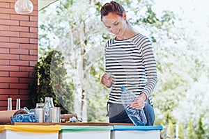 Woman recycling plastic bottle