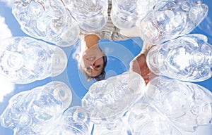 Woman recycling plastic water bottles high key