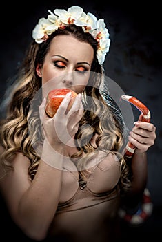 Woman with red apple and snake