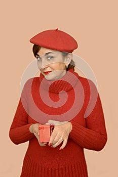 Woman in red with beret holding a gift
