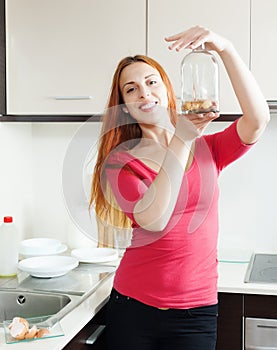 Woman in red cleaning bottle with egg shell