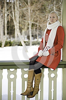 Woman in red coat sit at boundary