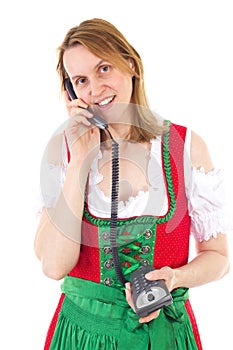 Woman in red dirndl dialing friend