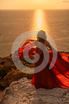 Woman in red dress, fashion model in evening dress, soaring in the street, sunset