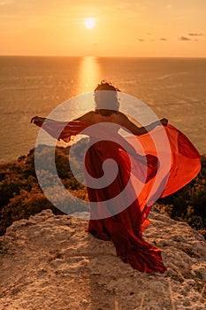 Woman in red dress, fashion model in evening dress, soaring in the street, sunset