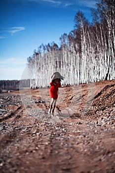 Woman in red dress in forest