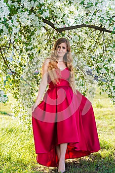 Woman in a red dress in garden
