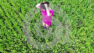 Woman in red dress having fun outdoors, dancing and spinning, happiness, inspirational, heaven, shot from top, above