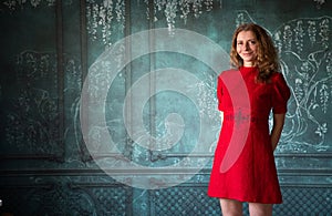 woman in red dress holding red rose