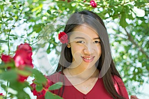 Woman in red dress with red rose in her hair