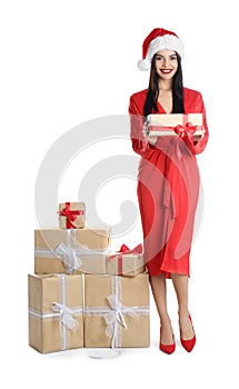 Woman in red dress and Santa hat with Christmas gifts on white background