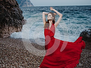 woman in red dress shore oceans posing fashion silhouette