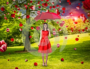 Woman in red dress with umbrella in summer park