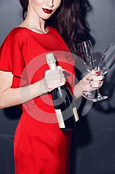 Woman in red dress wich champagne