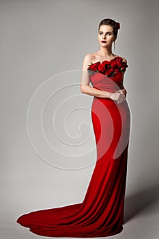 Woman in Red Evening Dress with Flowers Roses, Elegant Fashion Model Beauty Portrait in Long Gown, Studio Portrait