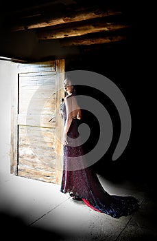 Woman in red evening dress standing in doorway