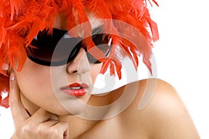 Woman with red feather wig and sunglasses