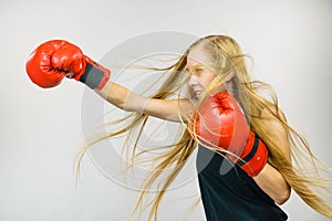 Woman in red gloves boxing