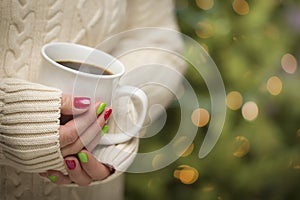 Woman with Red and Green Manicure Holding Cup of Coffee