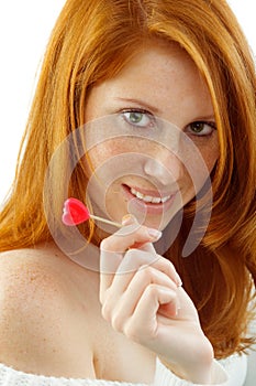 woman with red hair holding a heart