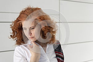 Woman with red hair posing on a white background