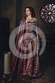 Woman with red hair wearing elegant royal garb