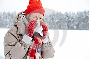 Woman in red hat having running nose and feeling unwell