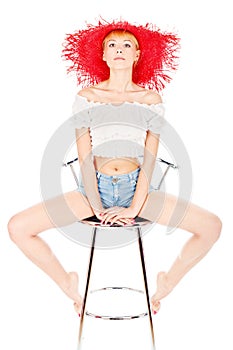 Woman with red hat sitting on the chair