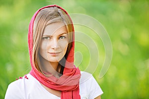 Woman in red headscarf smiles