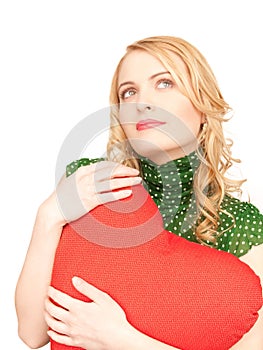 Woman with red heart-shaped pillow