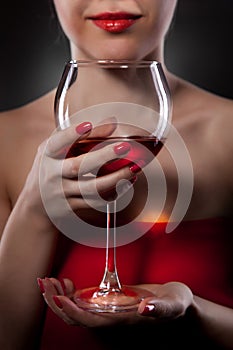 Woman in red holding wine glass