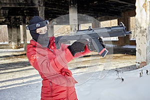 Woman in red jacket aiming with gaming gun outdoor photo