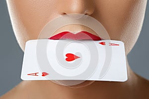 Woman with red lips and ace card in her mouth