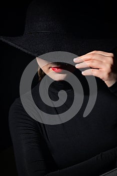 A Woman With Red Lips In A Black Hat photo