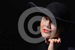 A Woman With Red Lips In A Black Hat photo