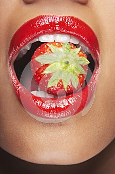 Woman With Red Lips Eating Strawberry
