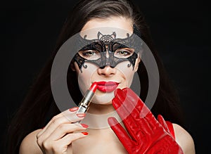 Woman with red lips makeup and trendy color lipstick on black background