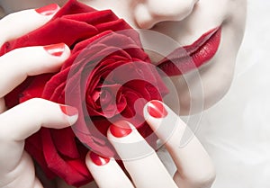 Woman with red lips, nails and rose