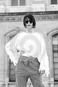 Woman with red lips in sunglasses, fashionable clothes