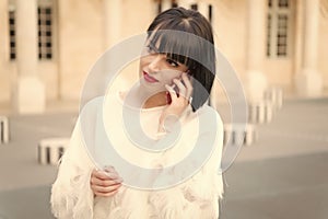 Woman with red lips talk on smartphone in paris, france. Woman with brunette hair hold mobile phone. Beauty girl with