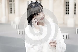 Woman with red lips talk on smartphone in paris, france. Woman with brunette hair hold mobile phone. Beauty girl with