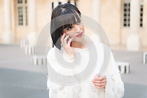 Woman with red lips talk on smartphone in paris, france. Woman with brunette hair hold mobile phone. Beauty girl with look. F