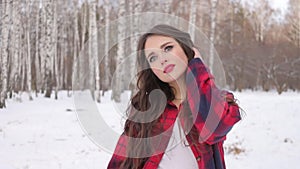 Woman with red lips in winter forest