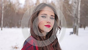 Woman with red lips in winter forest