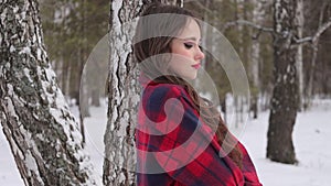 Woman with red lips in winter forest