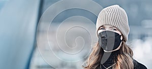 Woman with red long hair, blue eyes, young with FFP2 mask, wearing beige cap and black sweater, head portraits