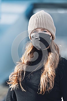 Woman with red long hair, blue eyes, young with FFP2 mask, wearing beige cap and black sweater, head portraits